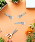 Go-To 2 Pack Stainless Steel Beekeeping Hive Tools Set, Hive Scraper And Frame Lifter on orange background with plants