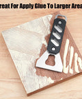 Built Tough Stainless Steel Glue Spreader And Notched Adhesive Applicator For Smooth Woodworking Projects applying glue on wood surface.