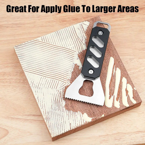 Built Tough Stainless Steel Glue Spreader And Notched Adhesive Applicator For Smooth Woodworking Projects applying glue on wood surface.