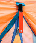 Orange Glow Reflective Trail Marker Clips with glow tape attached to tent, waterproof for hiking and hunting outdoors.