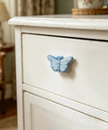 Blue butterfly knob from Six Piece Ceramic Drawer Knobs Set With Cute Butterfly Cabinet Pulls For Nursery And Kid Friendly Rooms Decorative Dresser Handles With Screws Ideal For Bedroom Bathroom And Shabby Chic Furniture Makeovers on white drawer
