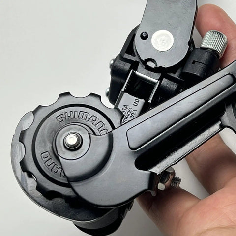 Close-up of Bike Rear Derailleur Tourney RD-TZ31 6 7 Speed Hanger Mount for MTB, highlighting durable alloy construction.