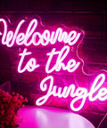 Welcome To The Jungle Neon Sign Pink LED Word Neon Light USB Powered Letter Light for bedroom decor, glowing on wall.
