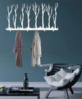 Rustic Winter Tree Grove Metal Wall Hooks with two coats hung, minimalist branch design for entryway decor.