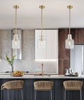 Kitchen island with modern linear chandelier, featuring Five Light Dope Farmhouse Pendant Lighting for Kitchen Island with Seeded Glass Shades.