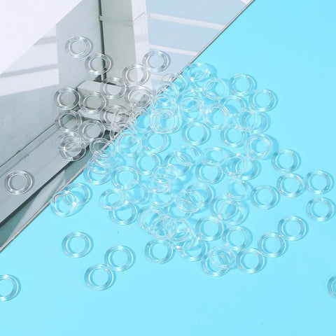 100 Pack Clear Plastic Roman Blind Curtain Rings Slick O Ring Clip Loops on blue surface for DIY home projects