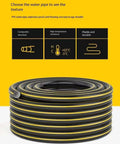 Hassle Free Wall Mounted Hose Reel With No Sweat Auto Rewind And Slick 180 Degree Swivel Bracket For Tangle Free Patio Garden Watering Holding Up To 32 Meters Of Heavy Duty Hose rolled PVC water pipe featuring black and yellow stripes.