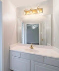 Bathroom with 3 Light Modern Vanity Light Fixture in Brass Finish With Clear Glass Shades For Bathroom, 22 Inch Long Wall Mount Vanity Lighting Bar above the mirror