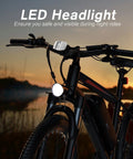 26 Inch Electric Mountain Bike With 350W Motor featuring LED headlight for night rides, shown during sunset with visible handlebars.