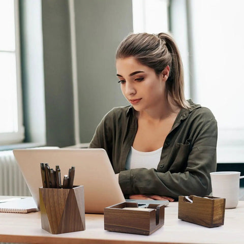 Woman using laptop with walnut wood sticky note holder and tape dispenser, rhombic pen holder desk organizer set nearby