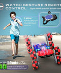 Child playing with 8WD Gesture Sensing RC Car with Spray Lights, 2.4GHz remote, showing offroad capabilities on beach, ideal gift for boys.