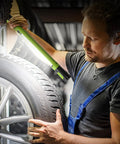 Mechanic using Cordless Underhood Work Light With Magnetic Base, 3000 Lumen LED, 5200mAh Rechargeable Battery to inspect tire