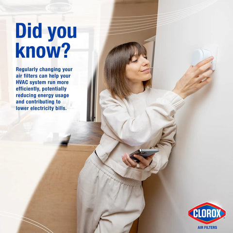 Person adjusting thermostat representing benefits of MERV 13 Pleated HVAC Air Filter 20X25X1 Pack Of 4 For Allergies, Dust, and Pollen.