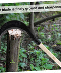 Hand Scythe Weeder Tool For Gardening And Grass Trimming Manganese Steel Blade resting on a cut tree stump in a forest