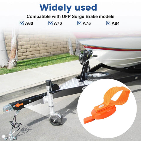 Orange QCG surge brake lockout key with strap, 2 pcs, shown on boat trailer hitch (front view).