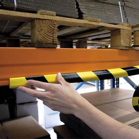 Person installing Tough As Nails Heavy Duty Wall Edge Corner Guards With Self Adhesive Foam Padding, Extra Long 196.9In 5m Yellow And Black Bumpers