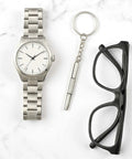 Compact 4 Piece Mini Eyeglass Screwdriver Set With 3 In 1 Flathead And Phillips Drivers, Eyeglass Tightener Keychain next to watch and glasses