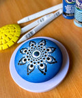 4 Inch Lazy Susan Turntable for Dotting and Mandala Art with decorated blue stone, wooden table surface, crafting tools.