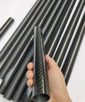 Hand holding Two Pack 3K Carbon Fiber Tube 24x20mm 24x22mm 24.29x23mm 500mm Length Pro Grade Lightweight Beefy Strength for DIY