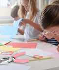 Kids using Handheld Paper Hole Punch Set With 1/16 Inch Small Circle And 1/8 Inch Medium Circle One Hole Punch Tool in a classroom.