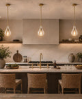 HXXLFONEDP Champagne Gold Pendant Light for Kitchen Island, Clear Glass in a modern kitchen setting over a countertop.