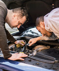 Two men examining a car engine, using internal tooth lock washers star shaped set in stainless steel for industrial fastening.