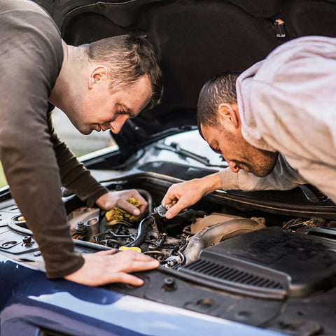 Two men examining a car engine, using internal tooth lock washers star shaped set in stainless steel for industrial fastening.