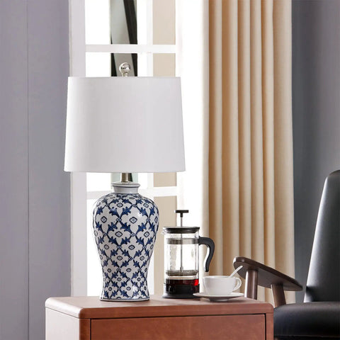 Blue Ceramic Table Lamp With White Fabric Shade Chinoiserie Urn Style Hand Painted Detail on wooden table beside coffee set