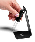 Hand using magnetic WDT tool for espresso puck prep with 120 degree adjustable angle, includes 0.25mm and 0.40mm needles.