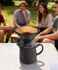 Real Heavy Duty Ceramic Pour Over Coffee Dripper Fits Standard Number Two And Four Paper Filters 15 Ounce Size on outdoor table with friends.