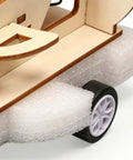 Close-up of a Wooden Vehicle Model Kit For Hands On Mechanical Engineering Fans showcasing wooden base and wheel detail.