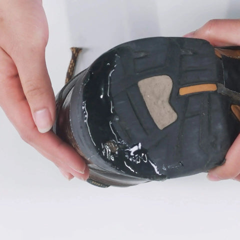 Applying Aquaseal SR Shoe Repair Adhesive for fixing holes in hiking boots, work boots; clear urethane glue on sole, 1 oz.