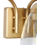 Close-up of gold finish base and clear glass shades in Gold Vanity Light Fixture Set With Clear Glass Shades, Modern 3 Light Over Mirror Bath Lighting, 22 Inch Long, Sleek Gold Finish Bath Bar Lights That Look Totally Lit.