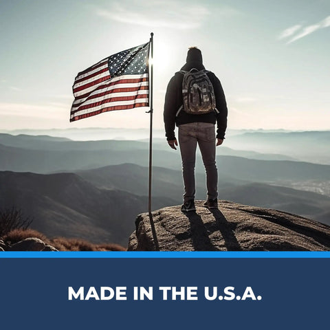 Hiker standing on a rock with American flag, symbolizing Ape Canyon Outfitters 3 Step Aider For Hunters And Arborists Lightweight Tree Climbing Tool Made In USA Coyote Ready For Safe Elevations And Quick Escalation In The Field.