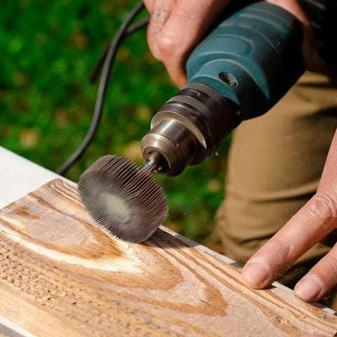 Close-up of Twenty Piece Pro Grade Abrasive Flap Wheel Sander Set With Eight Flap Wheel Sizes And Two Cone Shapes, 80 Grit in use on wood.