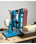 Zhenyuwang Electric Belt Sander 1100W Brushless Motor Pure Copper Windings on a workbench sanding a wood piece.