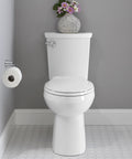 H2Optimum Two Piece Toilet Round Front Standard Height White 1.1 GPF With PowerWash Rim in a bathroom setting