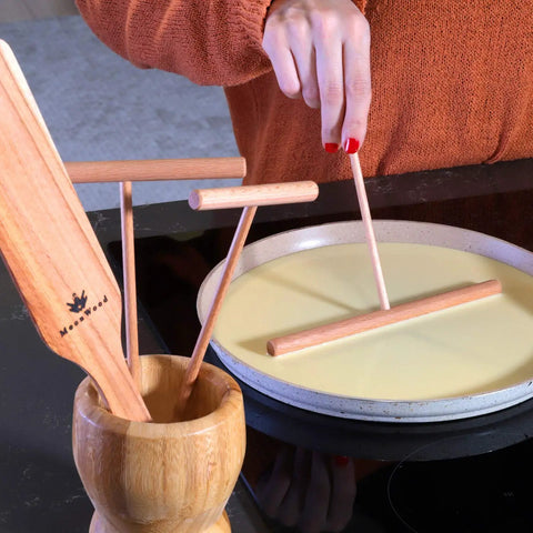 Crepe Spreader Set With Turner Four Piece Wooden Batter Tools 3.5 Inch 5 Inch 7 Inch 12 Inch T Shaped Design in use on a pan