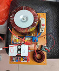 Circuit board with coils and electronic components placed on a chair.