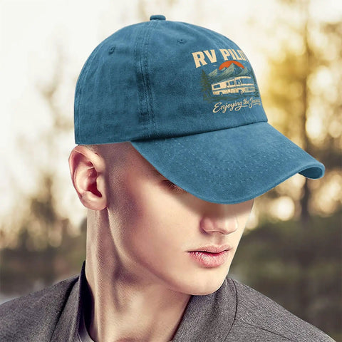 Man wearing Funny RV Pilot Hat For Men Cyan Blue Camper Road Trip Cap with Adjustable Strap, blurred outdoor background