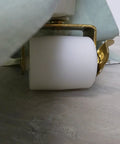 Side view of 2-1/8-Inch White Bed Rollers With Side Brake, 2-Pack For Furniture Moving, installed on a bed frame, on a wooden floor.