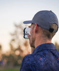 Person using Bang For Your Buck Budget Friendly Golf And Hunting Rangefinder With Seven X Magnification, 1200 Yard Distance outdoors