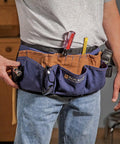 Person wearing heavy duty cotton tool belt apron built to last a real workhorse with 13 pockets for quick marking measuring and essential tools adjustable lightweight waist apron with hammer tool pouches and more for pro woodworking and DIY
