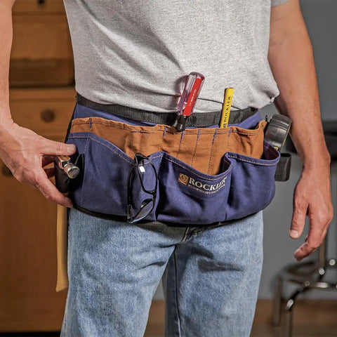 Person wearing heavy duty cotton tool belt apron built to last a real workhorse with 13 pockets for quick marking measuring and essential tools adjustable lightweight waist apron with hammer tool pouches and more for pro woodworking and DIY