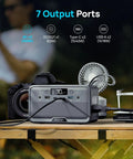 Pocket Sized Power Station With LiFePO4 Battery, 89.6Wh, connected to multiple devices on a wooden table outdoors.