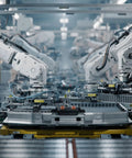 Automated robotic arms assembling components in a high-tech manufacturing facility.