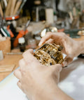 Hands holding Vintage Grandpa Clock Repair Weight Kit With Shell Hook And Nut Replacement Parts M5
