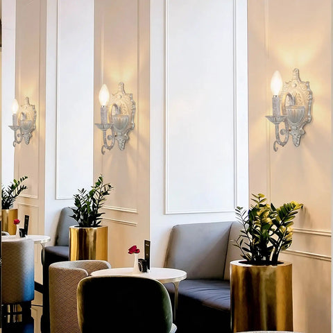 ZIRALIO Farmhouse Vintage Wall Sconce for Bedroom, 2-Pack mounted on cream wall in modern café setting with plants.