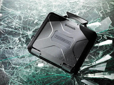 Built Like A Tank Rugged Laptop Toughbook CF 31 MK5 on shattered glass surface, showcasing durability and rugged design.