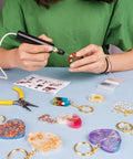 Person using Dope Electric Jewelry Drill Kit With 74 Piece Set Including Mini Hand Drill for resin jewelry crafting.